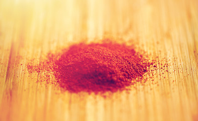 Image showing cayenne pepper or paprika powder on wood