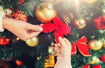 Image showing close up of family decorating christmas tree