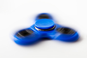 Image showing close up of blue spinning fidget spinner