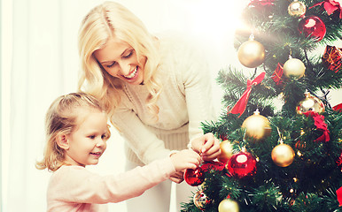 Image showing happy family decorating christmas tree at home