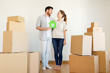 Image showing happy couple with boxes moving to new home