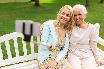 Image showing daughter and senior mother taking selfie at park