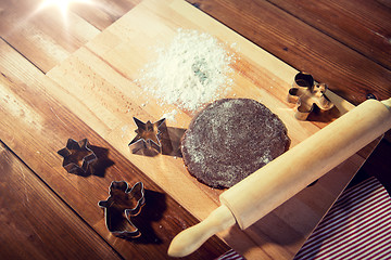 Image showing close up of ginger dough, molds and rolling pin