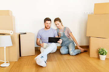 Image showing couple with boxes and tablet pc moving to new home