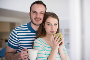 Image showing young handsome couple enjoying morning coffee