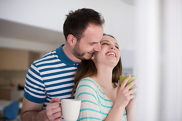 Image showing young handsome couple enjoying morning coffee