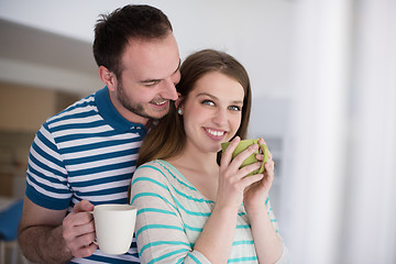 Image showing young handsome couple enjoying morning coffee