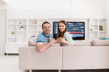 Image showing young handsome couple enjoying morning coffee