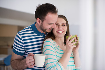 Image showing young handsome couple enjoying morning coffee