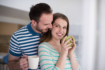 Image showing young handsome couple enjoying morning coffee