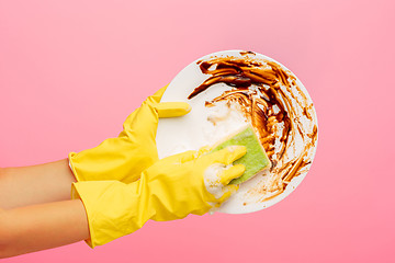 Image showing Hands in yellow protective gloves washing a plate