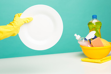 Image showing Hands in yellow protective gloves washing a plate