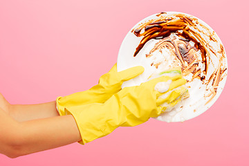 Image showing Hands in yellow protective gloves washing a plate