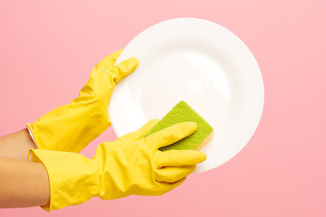 Image showing Hands in yellow protective gloves washing a plate