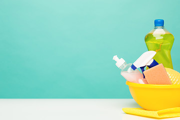 Image showing Various bottles with cleaning supplies on colored background