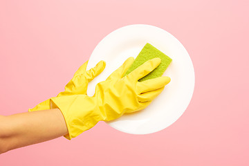 Image showing Hands in yellow protective gloves washing a plate