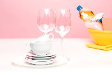 Image showing Several plates, a kitchen sponges and a plastic bottles with natural dishwashing liquid soap in use for hand dishwashing.