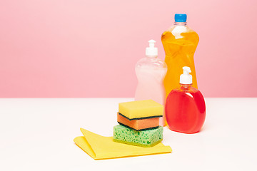 Image showing Various bottles with cleaning supplies on colored background