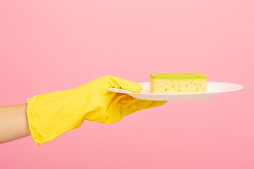 Image showing Hands in yellow protective gloves washing a plate