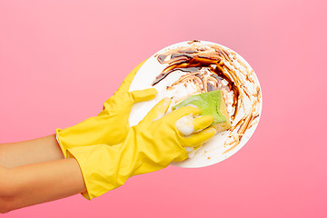 Image showing Hands in yellow protective gloves washing a plate