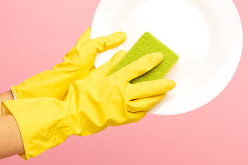 Image showing Hands in yellow protective gloves washing a plate