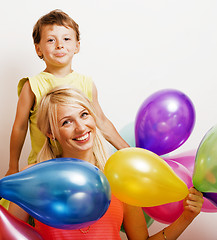 Image showing pretty family with color balloons on white background, blond woman with little boy on birthday party