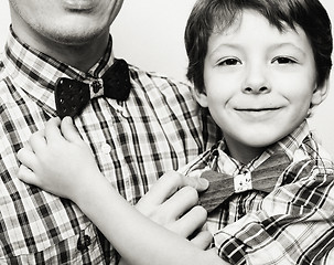 Image showing father with son in bowties on white background, casual look family