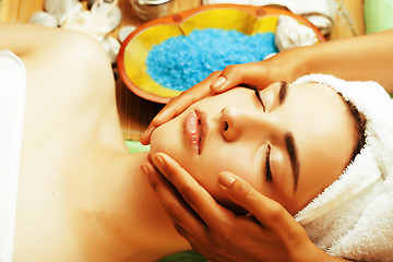 Image showing stock photo attractive lady getting spa treatment in salon, close up asian hands on face