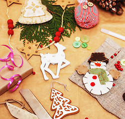 Image showing lot of stuff for handmade gifts, scissors, ribbon, paper with countryside pattern, ready for holiday concept, nobody home 