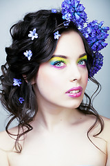 Image showing Beauty young woman with flowers and make up close up, real sprin