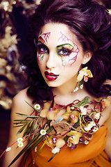 Image showing beauty woman with face art and jewelry from flowers orchids clos