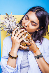 Image showing lifestyle people concept. young pretty smiling indian girl with pineapple, asian summer fruits 