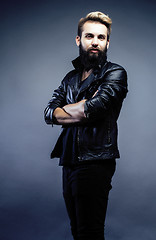 Image showing portrait of young bearded hipster guy on gray dark background close up, brutal modern man, lifestyle people concept 