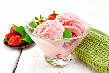 Image showing Ice cream strawberry in glass with berries on light board