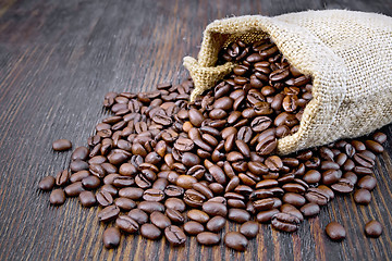 Image showing Coffee black grain in bag on board