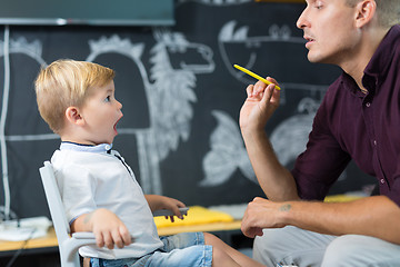 Image showing Cute little boy at speechtherapist session.