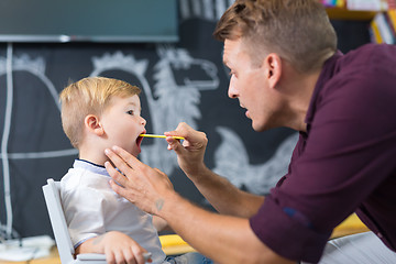 Image showing Cute little boy at speechtherapist session.