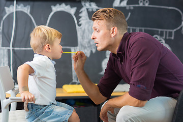 Image showing Cute little boy at speechtherapist session.