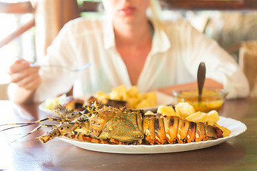 Image showing Grilled lobster served with potatoes and coconut sauce.