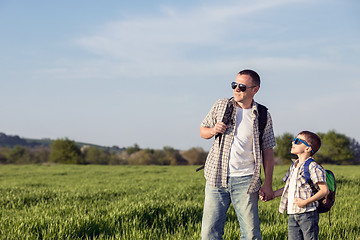 Image showing Father and son playing on the field at the day time.