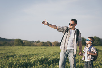 Image showing Father and son playing on the field at the day time.