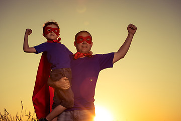 Image showing Father and son playing superhero at the sunset time.