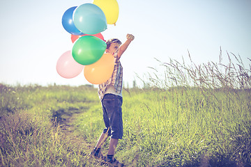 Image showing Happy little boy playing on road at the day time.