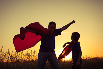 Image showing Father and son playing superhero at the sunset time.