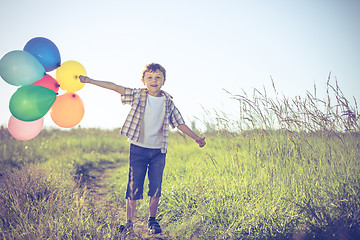 Image showing Happy little boy playing on road at the day time.