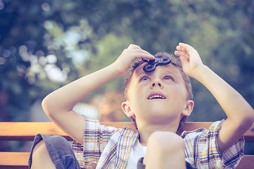 Image showing Happy little boy playing in the park at the day time.