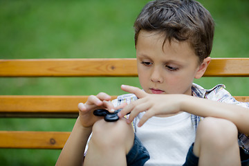 Image showing Happy little boy playing in the park at the day time.