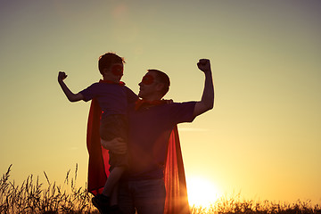 Image showing Father and son playing superhero at the sunset time.