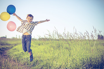 Image showing Happy little boy playing on road at the day time.