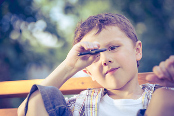 Image showing Happy little boy playing in the park at the day time.